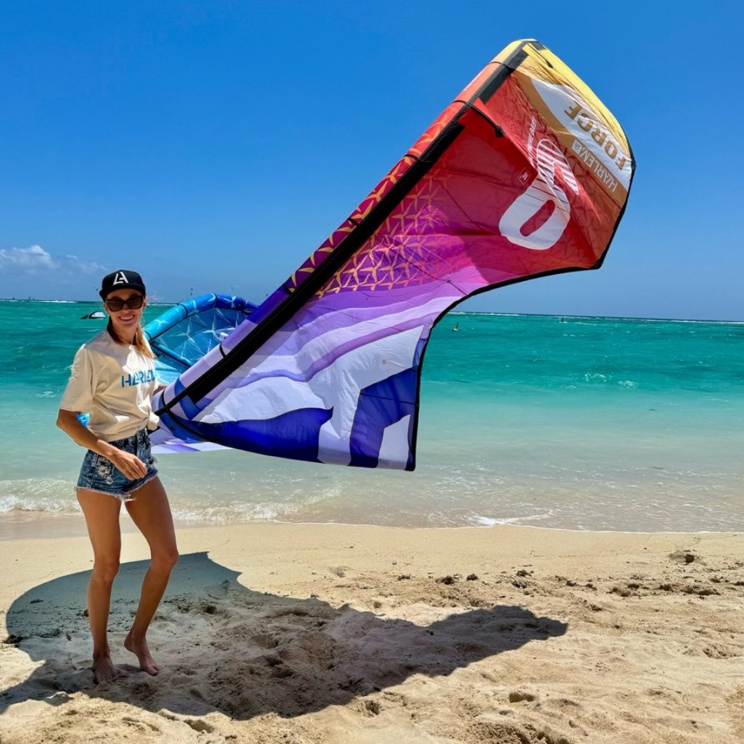 Student launching a kite in Le Morne lagoon, Mauritius