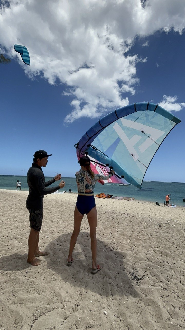 Student and instructor beginning a private wingfoil lesson on the beach