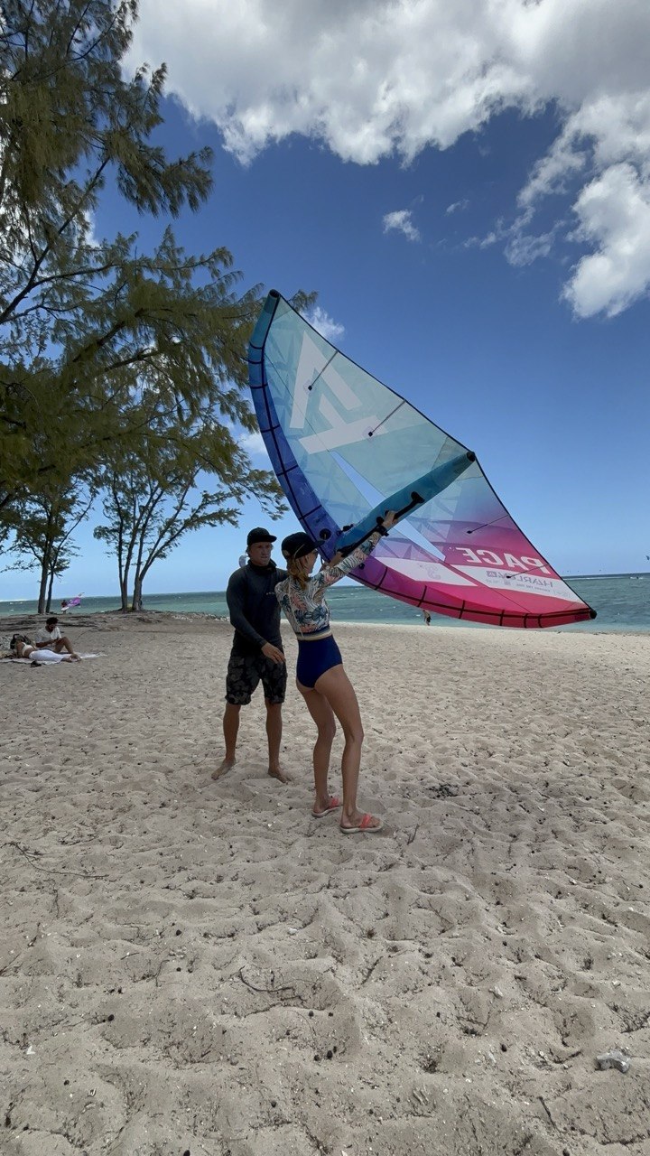 Instructor matching the wingfoil setup to a private student